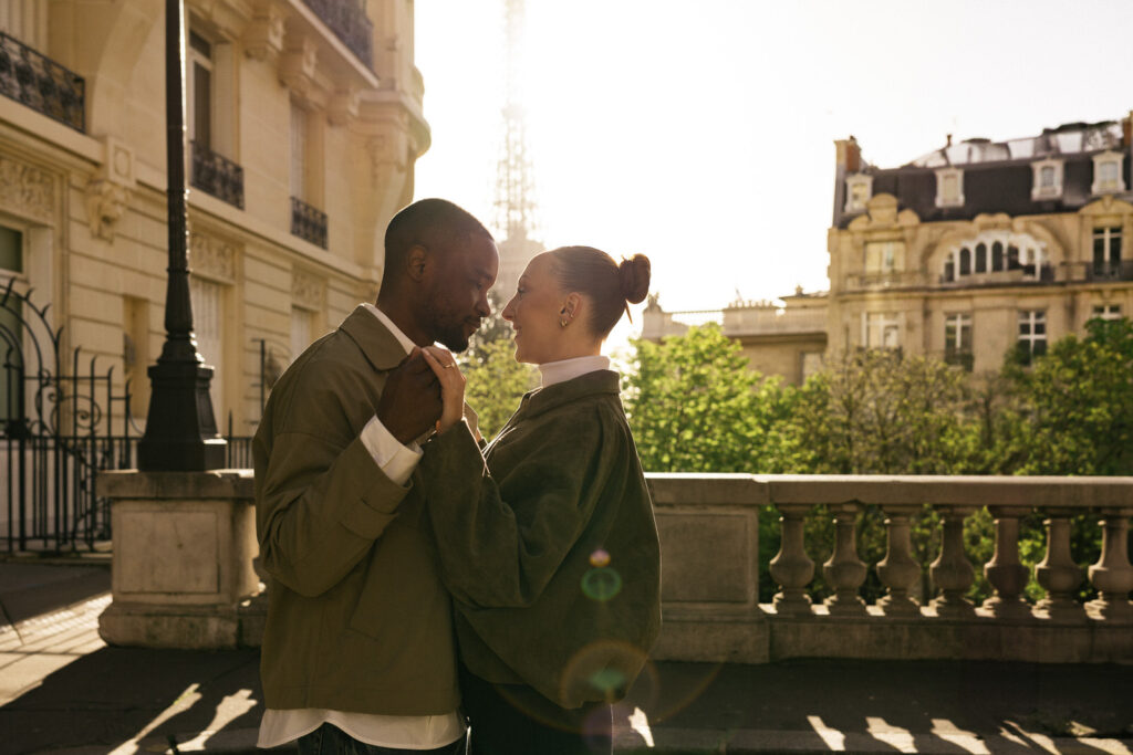 couple looking at each other with golden light eiffel tower