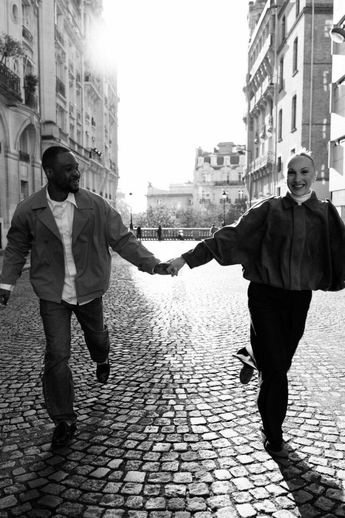 couple running streets paris black and white