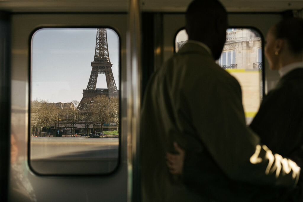 couple watching eiffel tower from metro